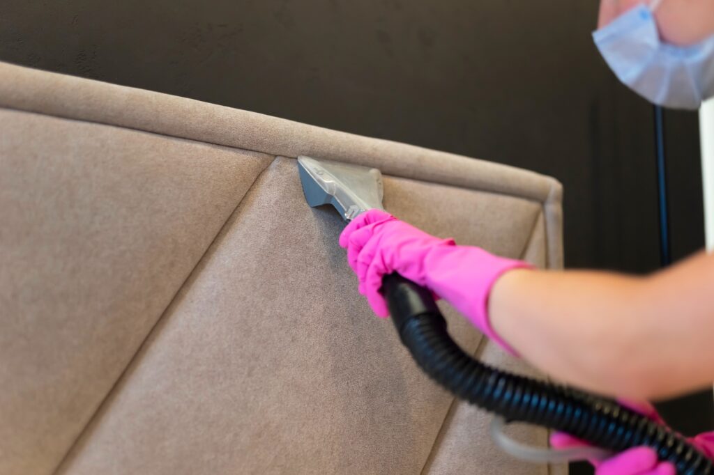 Cleaning the headboard with a washing vacuum cleaner